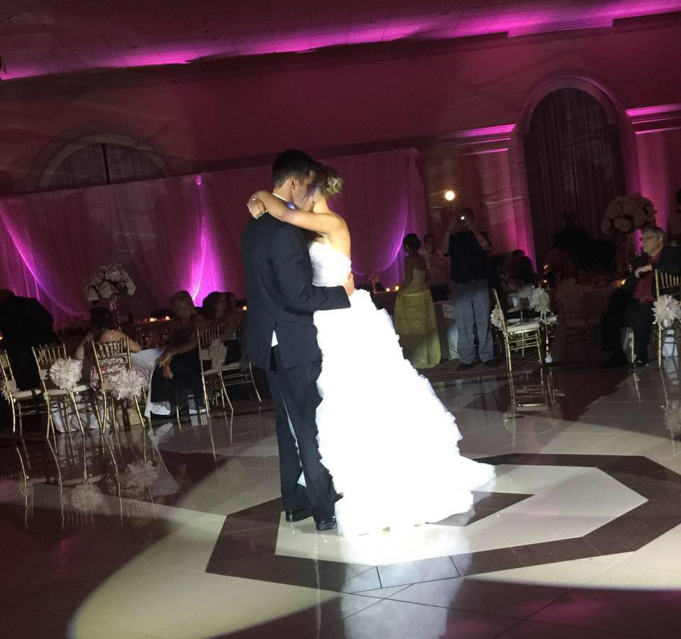 Bride and groom dancing in the spotlight during first dance with uplighting in detroit MI, Wedding Packages
