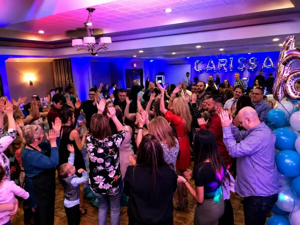 Professional Michigan Party DJ entertaining guests with interactive dancing, customized music, premium sound systems, and event lighting at a private party celebration.
