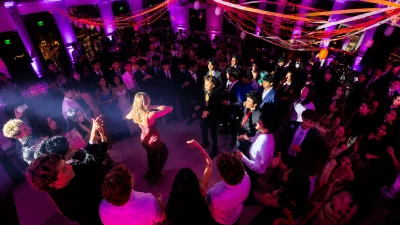 Michigan School DJ entertaining students with LED foam light sticks, professional lighting, and an interactive dance floor.