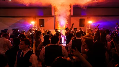Michigan School DJ creating a high-energy school dance with professional uplighting, intelligent dance floor lighting, and special effects for students.